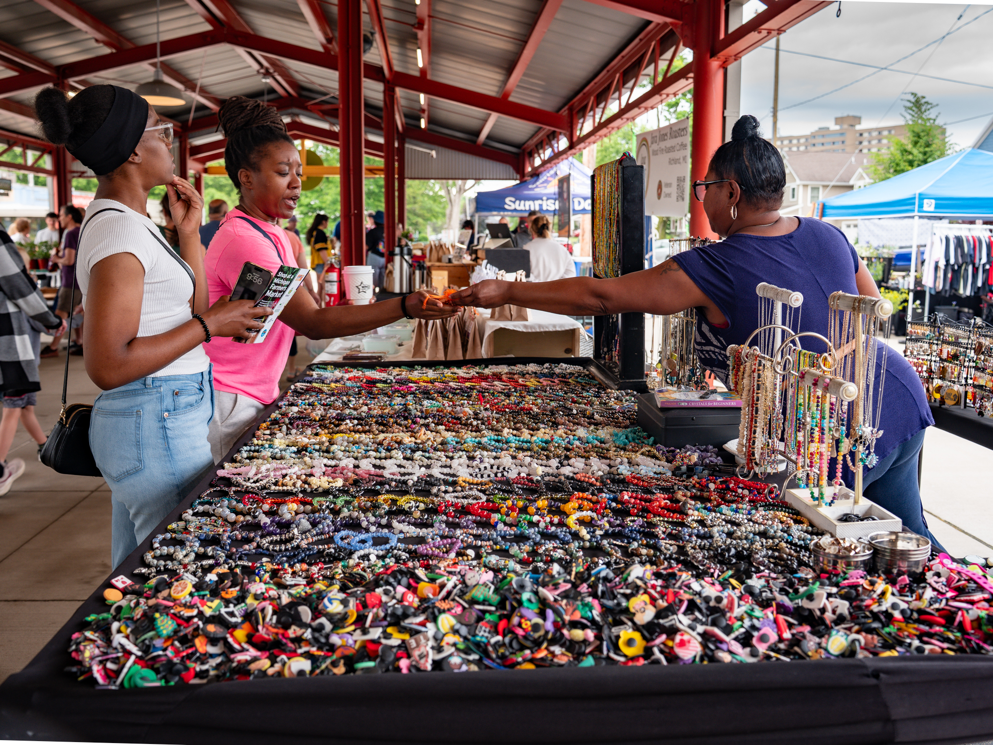People connecting with a local vendor at an outdoor community market