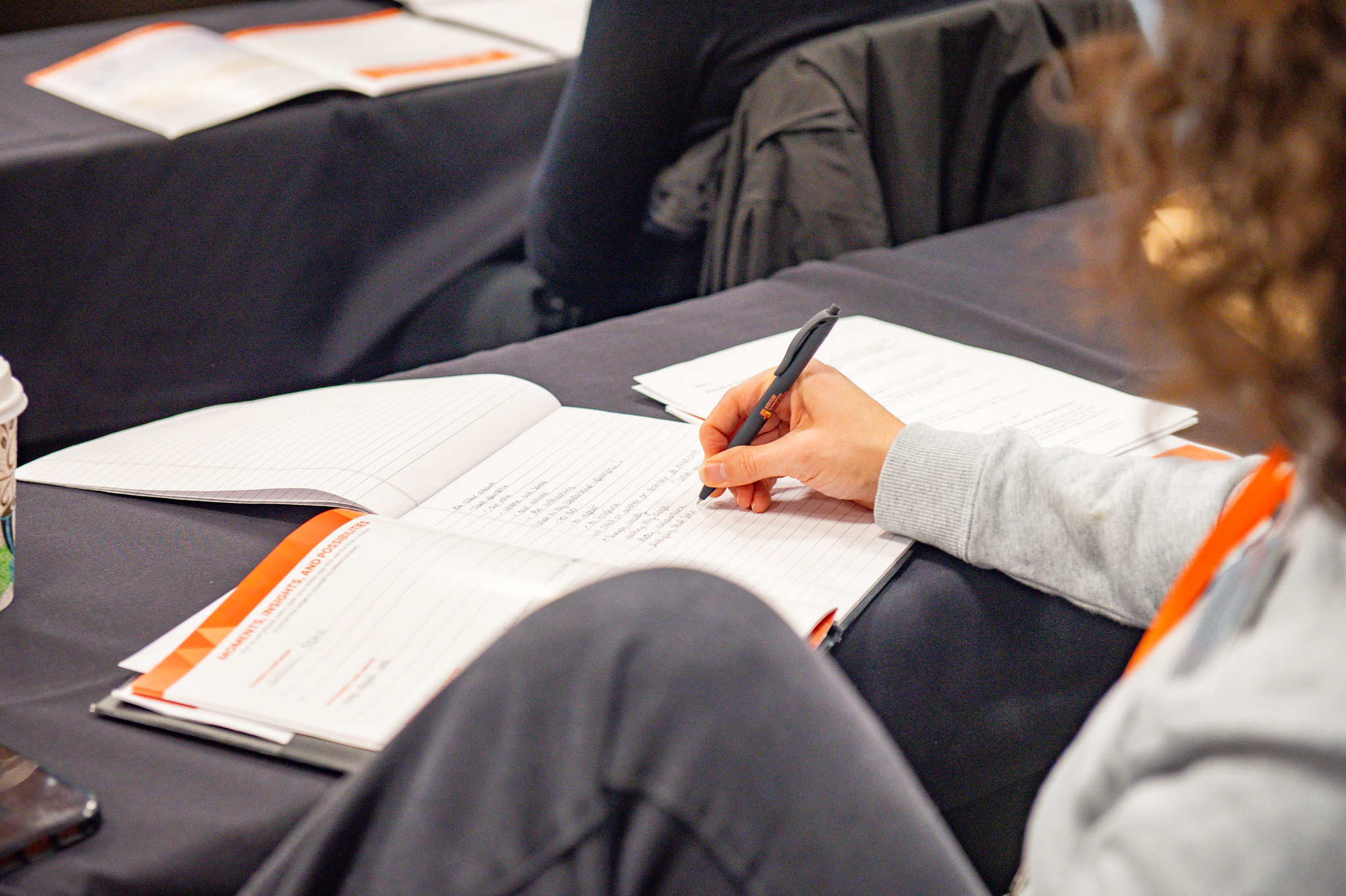 A participant taking notes during a Stryker Johnston Foundation convening